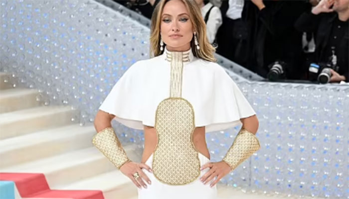 Olivia Wilde turned heads in a high-necked white gown with dazzling gold details.