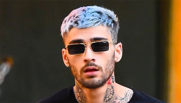 Zayn Maliks mysterious blonde companion ignites fan frenzy with intimate photo.
