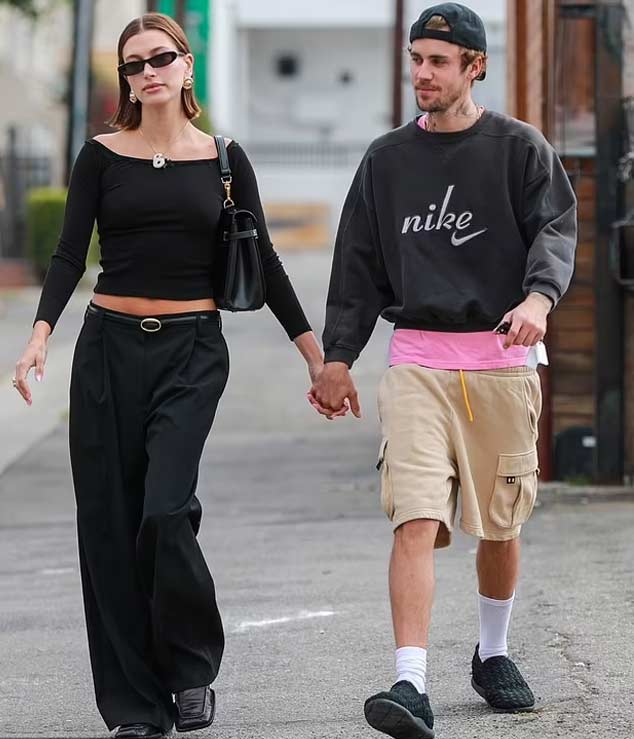 The lovebirds are holding hands on their way to the coffee shop