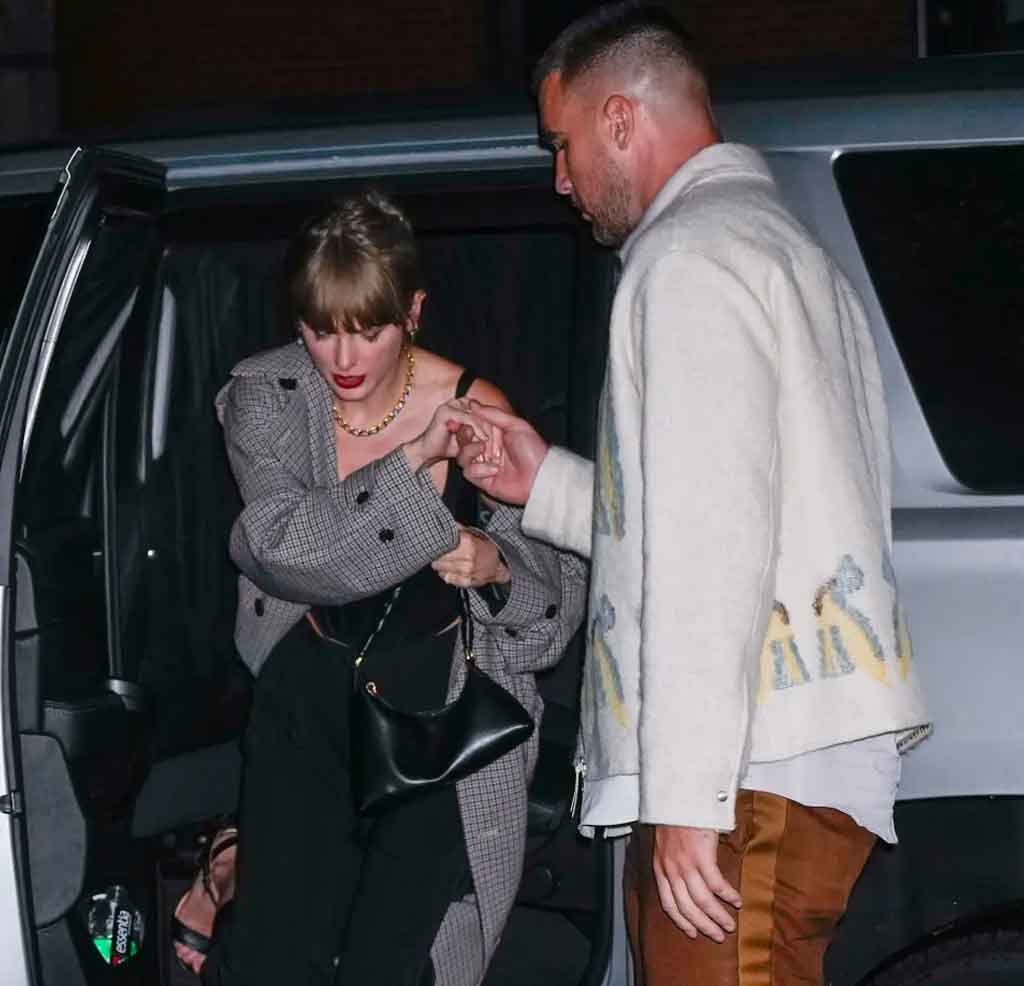 Travis helping Taylor as she steps out from the SUV