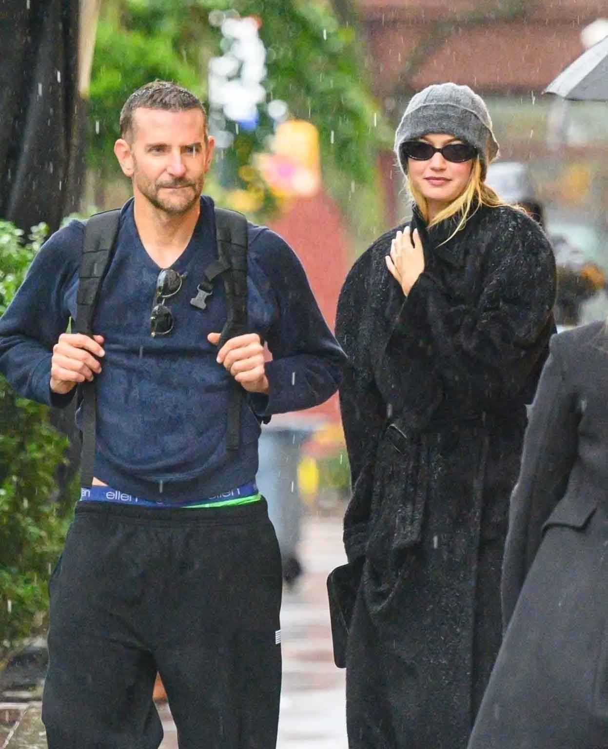 Bradley Cooper and Gigi Haded caught in rain