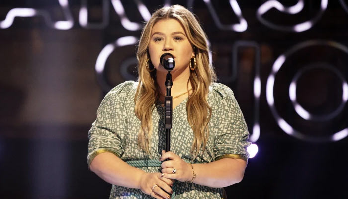 Kelly Clarkson is celebrating the festive season by singing Christmas songs