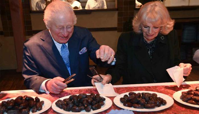 Britains King Charles III and Britains Queen Camilla help pack donation boxes dates at Indian restaurant Darjeeling Express, during a visit ahead of Ramadan, in London on February 26, 2025. —AFP