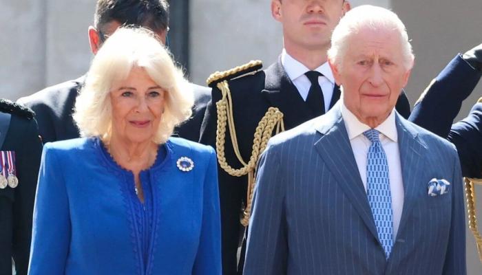 King Charles is seen standing beside the Italian hosts as he waits for Camilla to join them