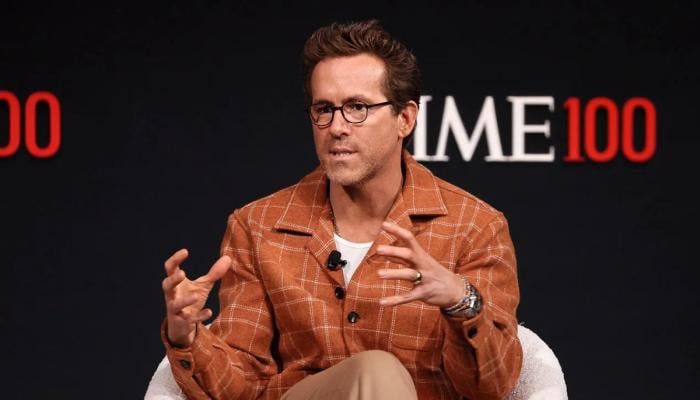 Ryan Reynolds manifesting two superheroes to crossover